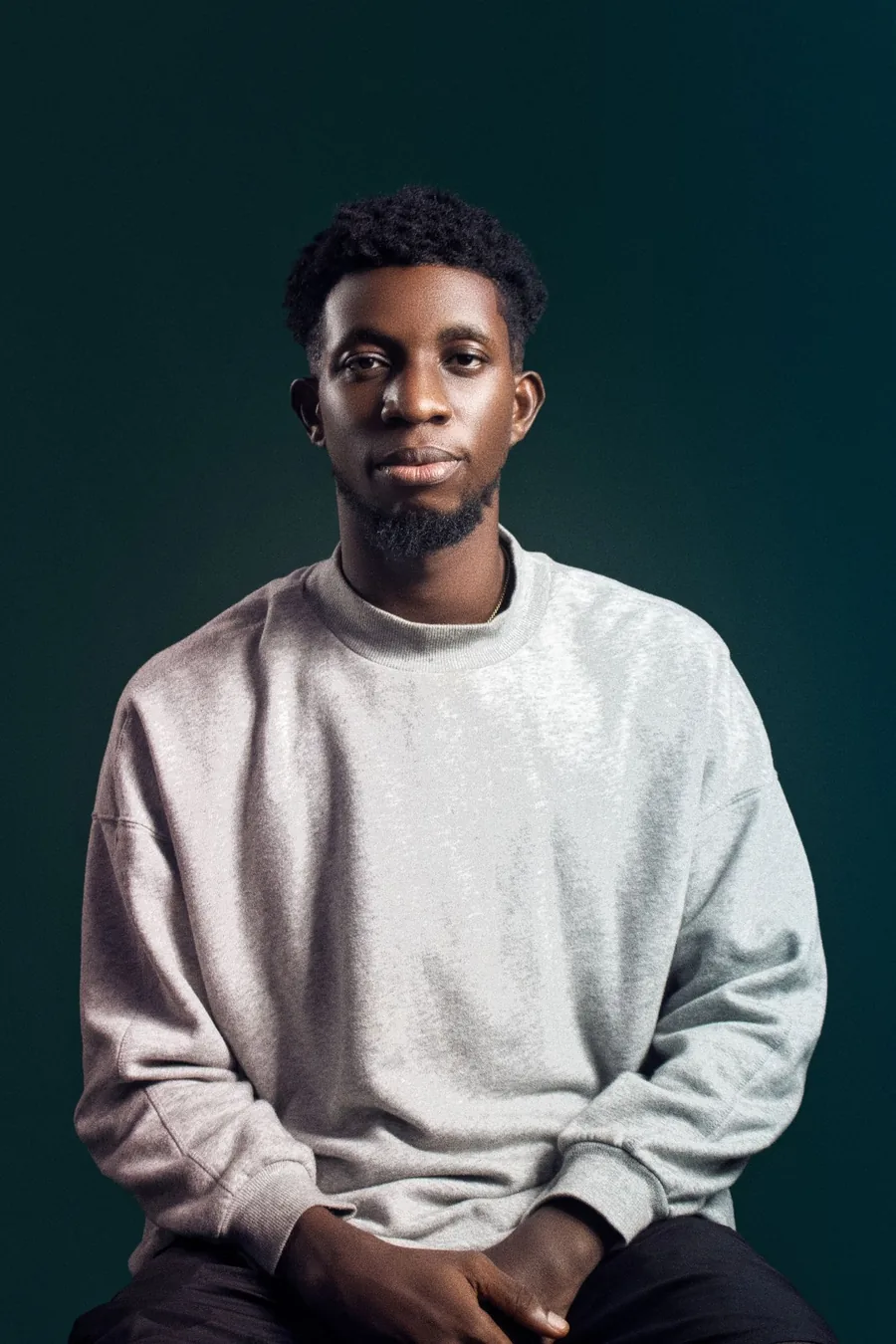 Miracle Jude seated, wearing a grey sweatshirt